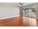 Bedroom with shiny wood floors and sliding glass doors to the outdoor terrace at 1110 W Ivanhoe Blvd # 5, Orlando, FL 32804