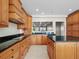 Well-lit kitchen with black countertops, wood cabinets, and tile flooring at 1110 W Ivanhoe Blvd # 5, Orlando, FL 32804