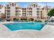 Relaxing swimming pool featuring lounge chairs and umbrellas with beautiful building in background at 1110 W Ivanhoe Blvd # 5, Orlando, FL 32804