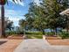 Water view from the backyard features lush green landscaping and lovely hardscape design at 12104 Lakeshore Dr, Clermont, FL 34711