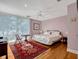 Bedroom featuring light-colored walls, ceiling fan, and large window with sheer curtains at 12104 Lakeshore Dr, Clermont, FL 34711