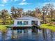 Gorgeous home features a boat lift and serene waterfront views at 12104 Lakeshore Dr, Clermont, FL 34711