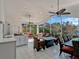 Entertainer's lanai, featuring wicker furniture, a summer kitchen, and lake view at 12104 Lakeshore Dr, Clermont, FL 34711