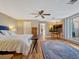 Main bedroom featuring access to the lanai, wood floors, and ensuite at 12104 Lakeshore Dr, Clermont, FL 34711