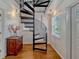 Unique spiral staircase with wooden steps and metal railings, adding architectural interest at 12104 Lakeshore Dr, Clermont, FL 34711