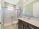 Bathroom featuring glass-enclosed shower and vanity with a quartz countertop at 1324 Arklow Cir, Ormond Beach, FL 32174