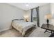 Cozy bedroom with neutral walls, soft carpet, and a patterned bed set near a window at 1324 Arklow Cir, Ormond Beach, FL 32174