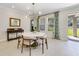 Light-filled dining area features a round table, modern lighting, and access to the outdoor space at 1324 Arklow Cir, Ormond Beach, FL 32174