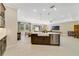 Spacious kitchen flowing into the living area and dining area, highlighted by a large island and modern fixtures at 1324 Arklow Cir, Ormond Beach, FL 32174