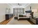 Tranquil main bedroom with a tray ceiling, hardwood floors, and elegant furnishings at 1324 Arklow Cir, Ormond Beach, FL 32174