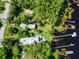 Aerial view of a lakefront estate surrounded by mature trees with multiple docks along the waterfront at 13344 S Lake Mary Jane Rd, Orlando, FL 32832