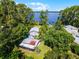 A waterfront estate nestled among lush trees with a dock, a covered dock and scenic lake views at 13344 S Lake Mary Jane Rd, Orlando, FL 32832