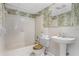 Full bathroom with a tub/shower combo and pedestal sink at 13344 S Lake Mary Jane Rd, Orlando, FL 32832