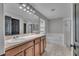 Spacious bathroom featuring dual sinks, a large mirror, a soaking tub, and neutral tile flooring at 1465 Osprey Ridge Dr, Eustis, FL 32736