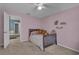 bedroom with a bed, pink walls, and access to the hall at 1465 Osprey Ridge Dr, Eustis, FL 32736