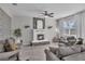 Comfortable living room featuring a fireplace, tile floors, and stylish gray sofas for relaxing and entertaining at 1465 Osprey Ridge Dr, Eustis, FL 32736