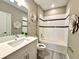 Inviting bathroom features a vanity with white countertop and tiled shower with decorative flower embellishments at 15209 Lake Lamonia St, Winter Garden, FL 34787