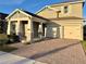 Charming two-story home featuring a 2-car garage and welcoming front porch with stone detailing on the columns at 15209 Lake Lamonia St, Winter Garden, FL 34787