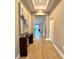 Inviting hallway with wood flooring, stylish console table, and elegant wall art at 15209 Lake Lamonia St, Winter Garden, FL 34787