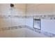 Detailed shot of a shower featuring a tile niche and decorative accent tiles at 15209 Lake Lamonia St, Winter Garden, FL 34787