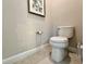 Powder room with standard toilet, neutral paint, base molding, and tile flooring at 15209 Lake Lamonia St, Winter Garden, FL 34787