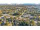 A wide aerial shot featuring homes nestled among lush trees with a cityscape backdrop, providing a sense of community at 1523 Silver Star Rd, Orlando, FL 32804