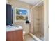 Tiled bathroom with a sink vanity, toilet, and a walk-in shower with a shower curtain at 1523 Silver Star Rd, Orlando, FL 32804