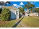 View of gray single-story house, lawn, and driveway on a sunny day with blue skies at 1523 Silver Star Rd, Orlando, FL 32804