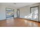 Living room with hardwood floors and view to sun room; features neutral wall color at 1523 Silver Star Rd, Orlando, FL 32804