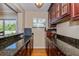 Wet bar with cabinets and black granite countertop at 1591 Chippewa Trl, Maitland, FL 32751