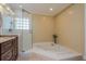 Bright bathroom with a large bathtub and a glass-enclosed shower, providing a relaxing spa-like experience at 1591 Chippewa Trl, Maitland, FL 32751