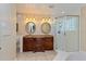 Bathroom featuring a double sink vanity with a granite countertop and a glass-enclosed shower at 1591 Chippewa Trl, Maitland, FL 32751