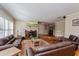 Cozy living room shows a fireplace, hardwood floors, neutral walls, and large window with wooden shutters at 1591 Chippewa Trl, Maitland, FL 32751