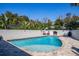 Relaxing in-ground pool with brick surround, white brick wall, and lounge chairs on a sunny day at 1591 Chippewa Trl, Maitland, FL 32751