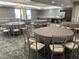 Elegant event space with round tables, chairs, and a kitchenette area at 16300 County Road 455 # 305, Montverde, FL 34756