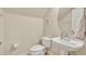 Elegant bathroom featuring modern fixtures, a pedestal sink, and a toilet with a minimalist design at 1725 Prospect Ave, Orlando, FL 32814