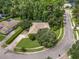 Aerial view showcasing the home's location on a tree-lined street with a lush yard at 1921 Redwood Grove, Lake Mary, FL 32746