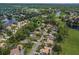 An aerial image of a community shows many homes nestled within a thicket of trees at 1921 Redwood Grove, Lake Mary, FL 32746