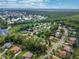 A drone shot of the neighborhood shows a lake and surrounding trees at 1921 Redwood Grove, Lake Mary, FL 32746