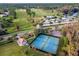 An aerial view showcasing tennis courts, a gazebo, and winding walking trails through lush trees at 1921 Redwood Grove, Lake Mary, FL 32746