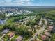 Aerial view of a well-maintained community featuring homes surrounded by trees and a serene lake at 1921 Redwood Grove, Lake Mary, FL 32746