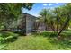 Lush backyard with a screened-in lanai and a variety of trees and plants at 1921 Redwood Grove, Lake Mary, FL 32746