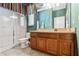 Bright bathroom with a glass-enclosed shower, modern vanity with a granite countertop, and colorful striped window dressings at 1921 Redwood Grove, Lake Mary, FL 32746