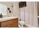 Well-lit bathroom with a vanity, toilet, and shower/tub combination with wooden accents and decor at 1921 Redwood Grove, Lake Mary, FL 32746