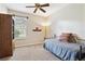 Cozy bedroom with natural light, ceiling fan, and carpeting featuring a twin bed and wood storage cabinet at 1921 Redwood Grove, Lake Mary, FL 32746