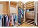 Well-organized walk-in closet with custom wood shelving, hanging rods, drawers, and hardwood floors at 1921 Redwood Grove, Lake Mary, FL 32746