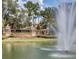 Beautiful community entrance featuring a decorative pond, fountain, and stone signage at 1921 Redwood Grove, Lake Mary, FL 32746