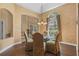 Elegant dining room with a glass table, decorative chandelier, and archways at 1921 Redwood Grove, Lake Mary, FL 32746