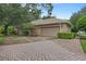 Side view of the house showing a garage with a driveway paved with pavers at 1921 Redwood Grove, Lake Mary, FL 32746