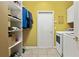 Bright laundry room with shelving, washer, dryer, and tile flooring, providing a functional and organized space at 1921 Redwood Grove, Lake Mary, FL 32746